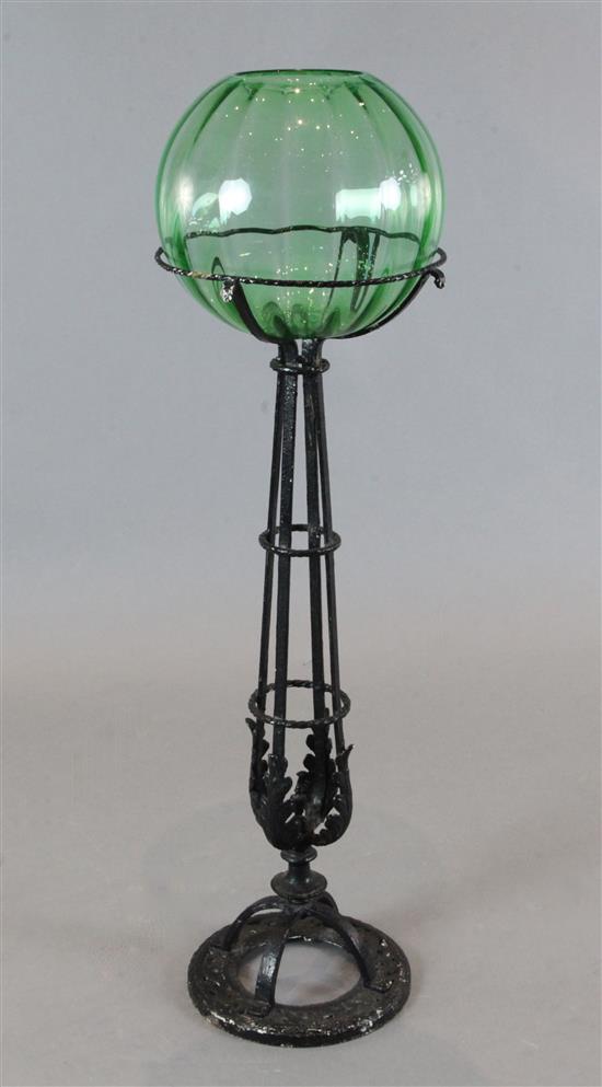 A Victorian uranium glass fish bowl on black painted wrought iron stand, H.43in.